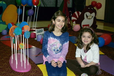Two Girls Posing for a Picture on the Life-Sized C